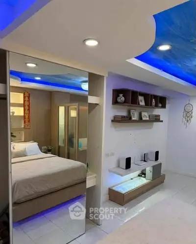 Modern bedroom with stylish ceiling lights and mirrored wardrobe in a cozy apartment.