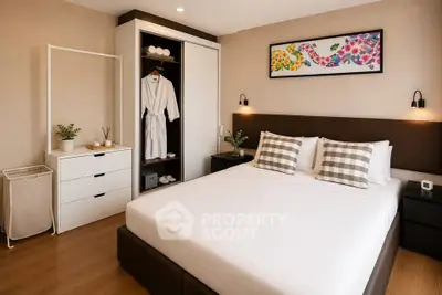 Modern bedroom with stylish decor, featuring a comfortable bed, elegant artwork, and ample storage space.