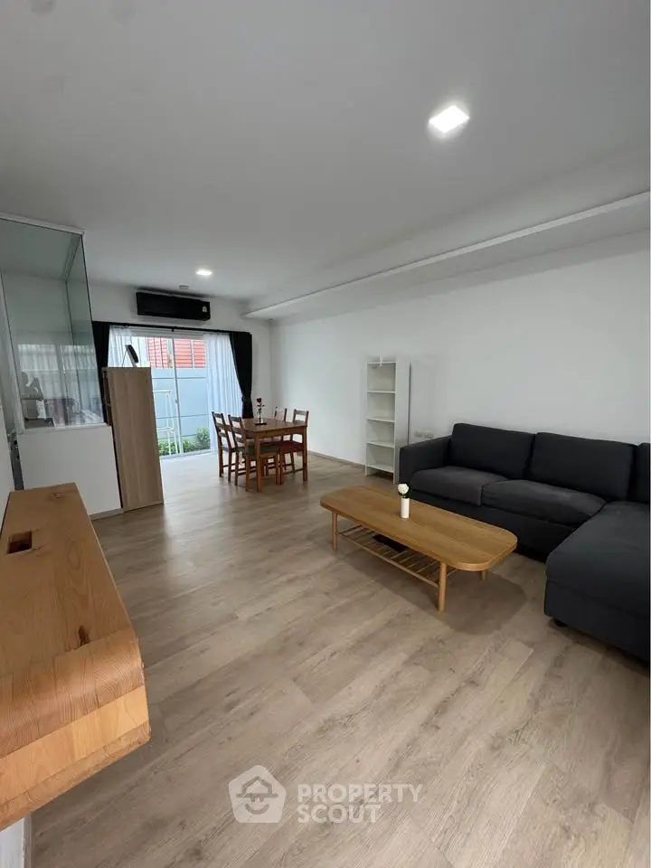 Spacious modern living room with wooden flooring and stylish furniture