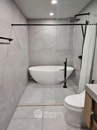 Modern bathroom with sleek freestanding bathtub and elegant fixtures