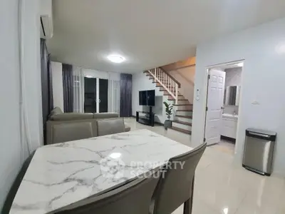 Modern living room with marble dining table and staircase in stylish home