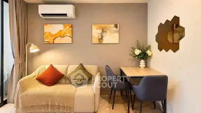 Modern living room with cozy sofa, stylish decor, and air conditioning unit.