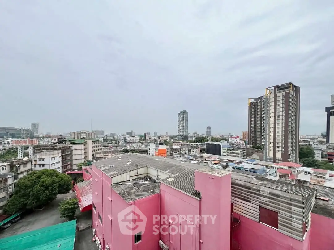 Stunning cityscape view with vibrant pink building and modern high-rises.