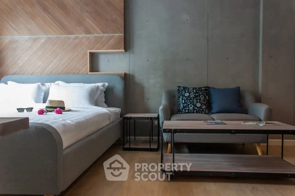 Modern bedroom with stylish decor and cozy seating area, perfect for relaxation and comfort.