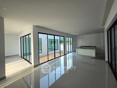 Spacious modern living area with glass walls and open layout