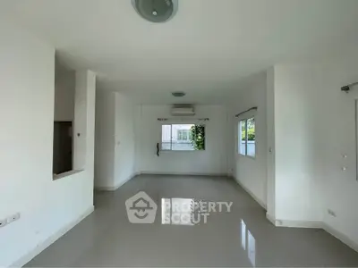 Spacious empty living room with large windows and glossy tiled floors, perfect for customization.