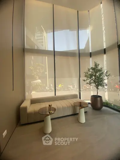 Modern living room with tall windows and elegant furniture