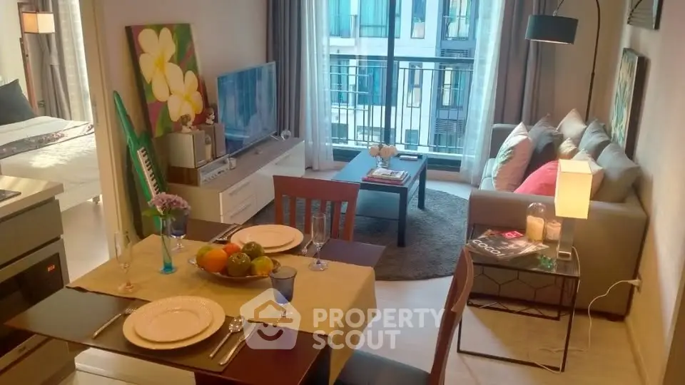 Modern living room with cozy seating and dining area, featuring large windows and stylish decor.