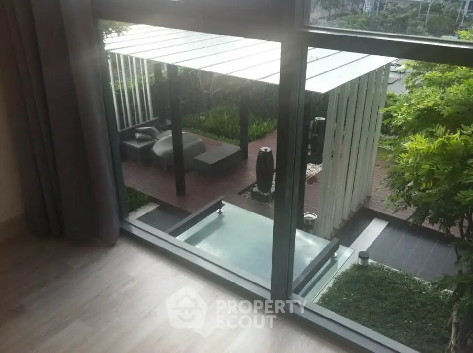 Luxurious garden view from modern apartment with private patio and greenery.