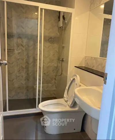 Modern bathroom with sleek shower and contemporary fixtures in a stylish apartment.