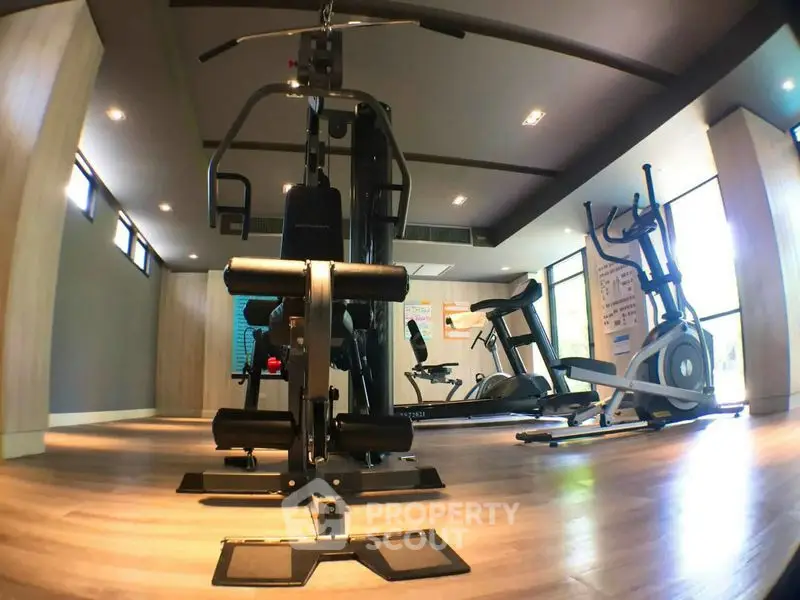 Modern gym with state-of-the-art fitness equipment in a stylish residential building.