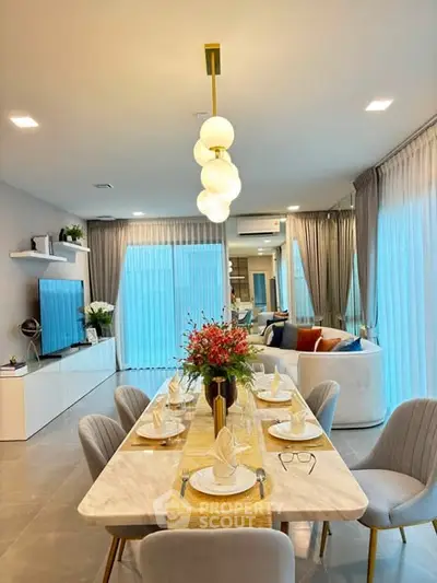 Elegant dining and living area with modern decor and natural light