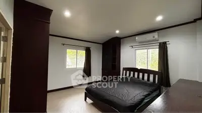 Spacious bedroom with modern furnishings and natural light