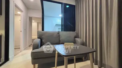 Modern living room with cozy sofa and stylish decor in a contemporary apartment.