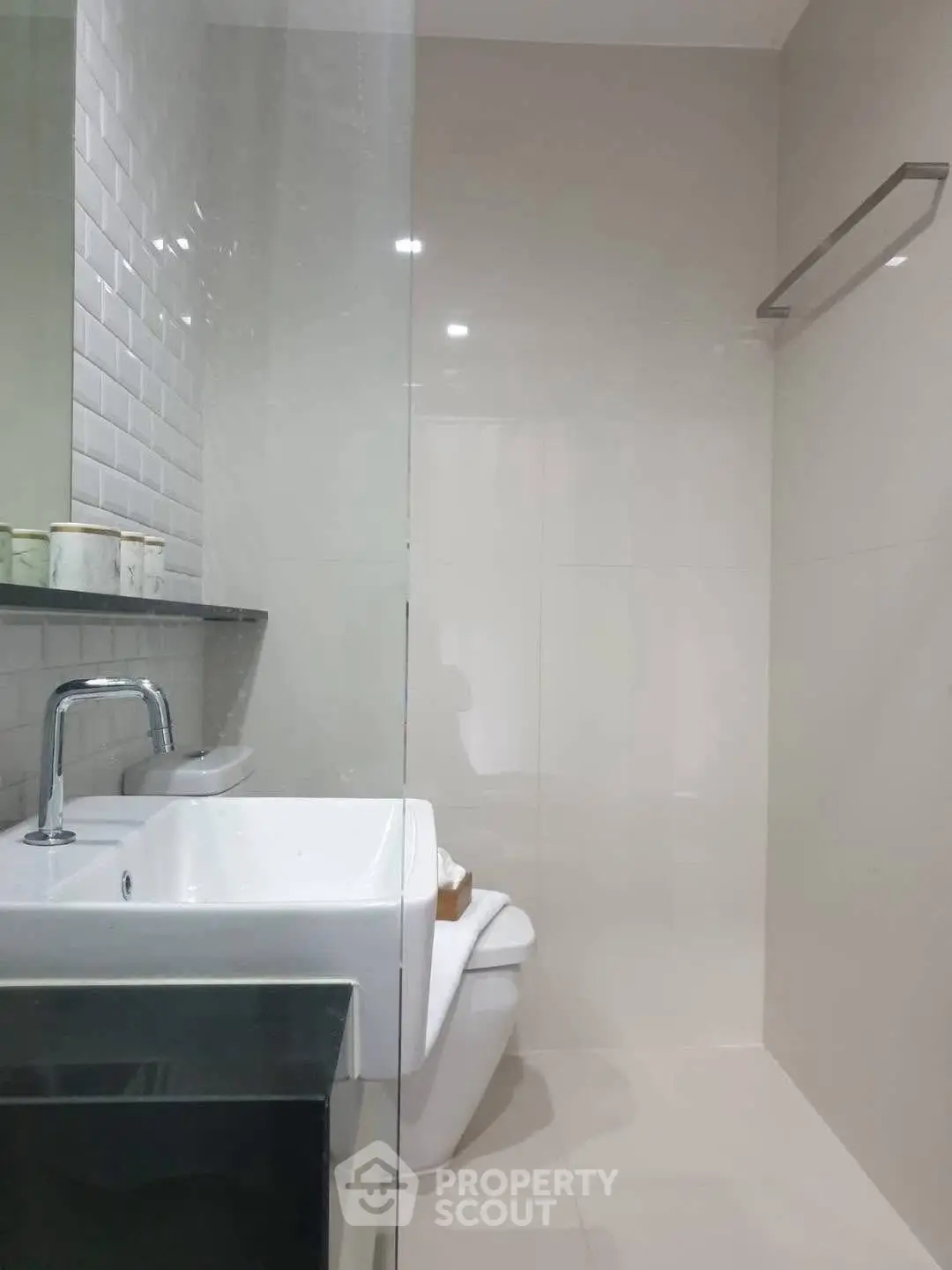 Modern bathroom with sleek design featuring a glass shower and contemporary fixtures.