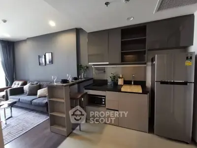 Modern open-layout kitchen and living room with sleek appliances and stylish decor.