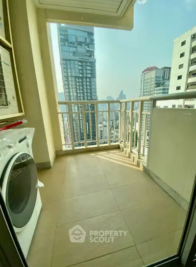 Spacious balcony with city view and washing machine, perfect for urban living.