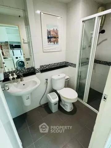 Compact bathroom with shower and modern fixtures in a stylish apartment.