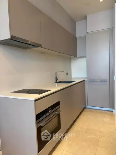 Modern kitchen with sleek cabinetry and built-in appliances in a stylish apartment.