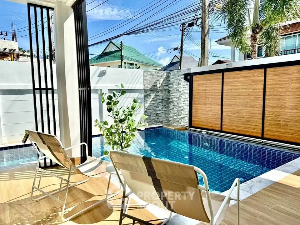 Luxurious private pool area with modern seating and lush surroundings.