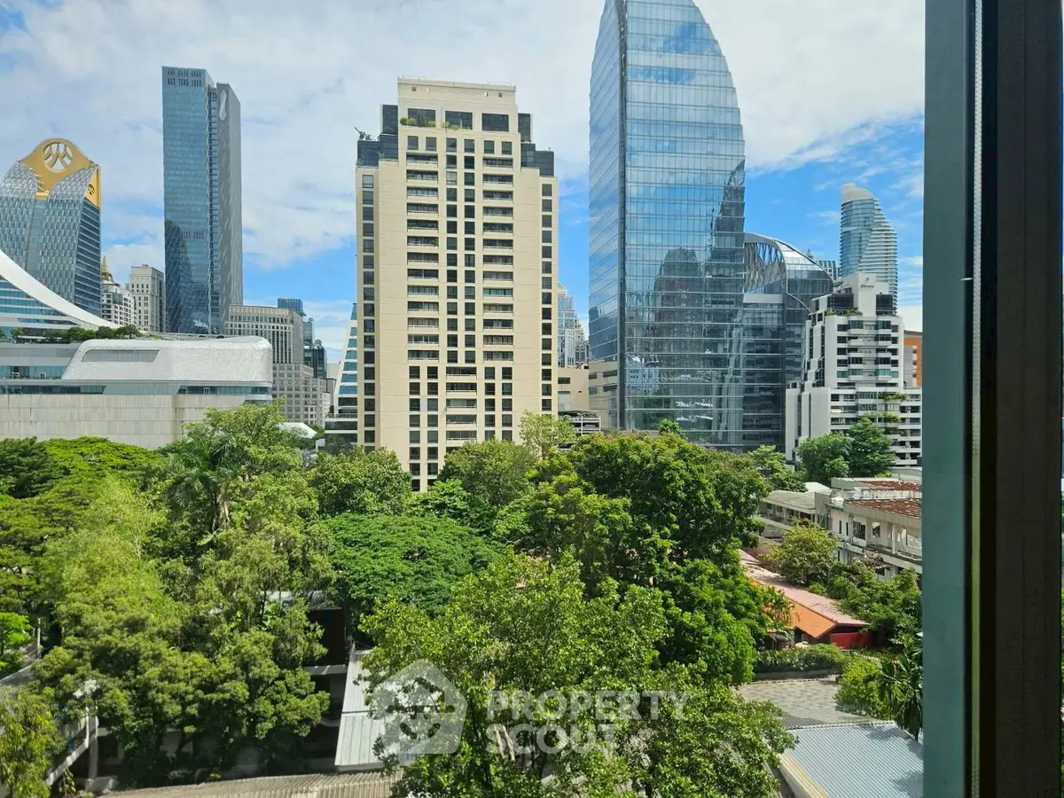 Stunning cityscape view with modern skyscrapers and lush greenery, perfect for urban living enthusiasts.