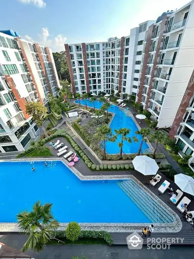 Luxurious apartment complex with stunning pool view and modern amenities.