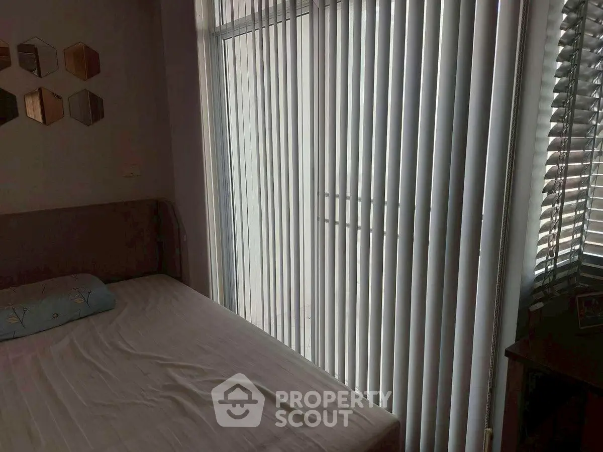 Cozy bedroom with vertical blinds and modern decor