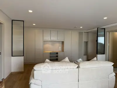 Spacious modern living room with elegant neutral tones and stylish lighting