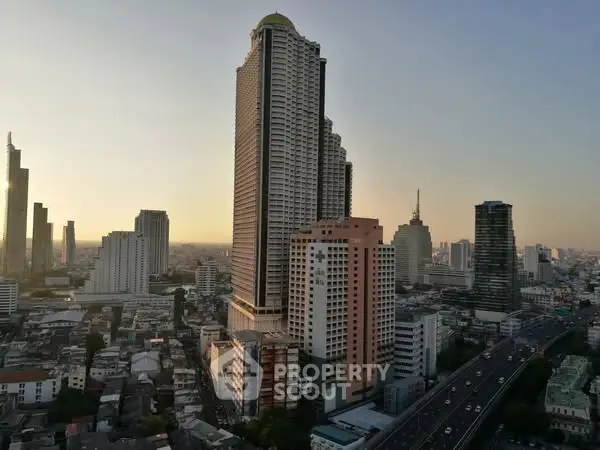 Stunning cityscape view featuring a prominent skyscraper at sunset, ideal for urban living enthusiasts.