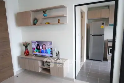 Modern living room with TV and kitchen view in stylish apartment