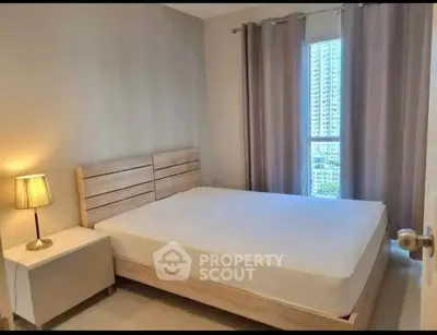 Cozy bedroom with modern decor and city view from window