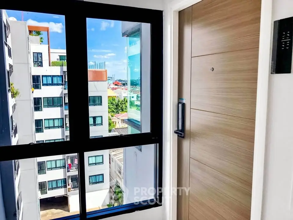 Modern apartment entrance with city view through large window
