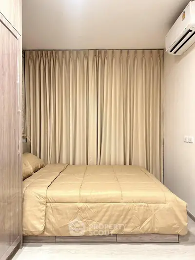 Cozy bedroom with elegant curtains and air conditioning, perfect for restful nights.
