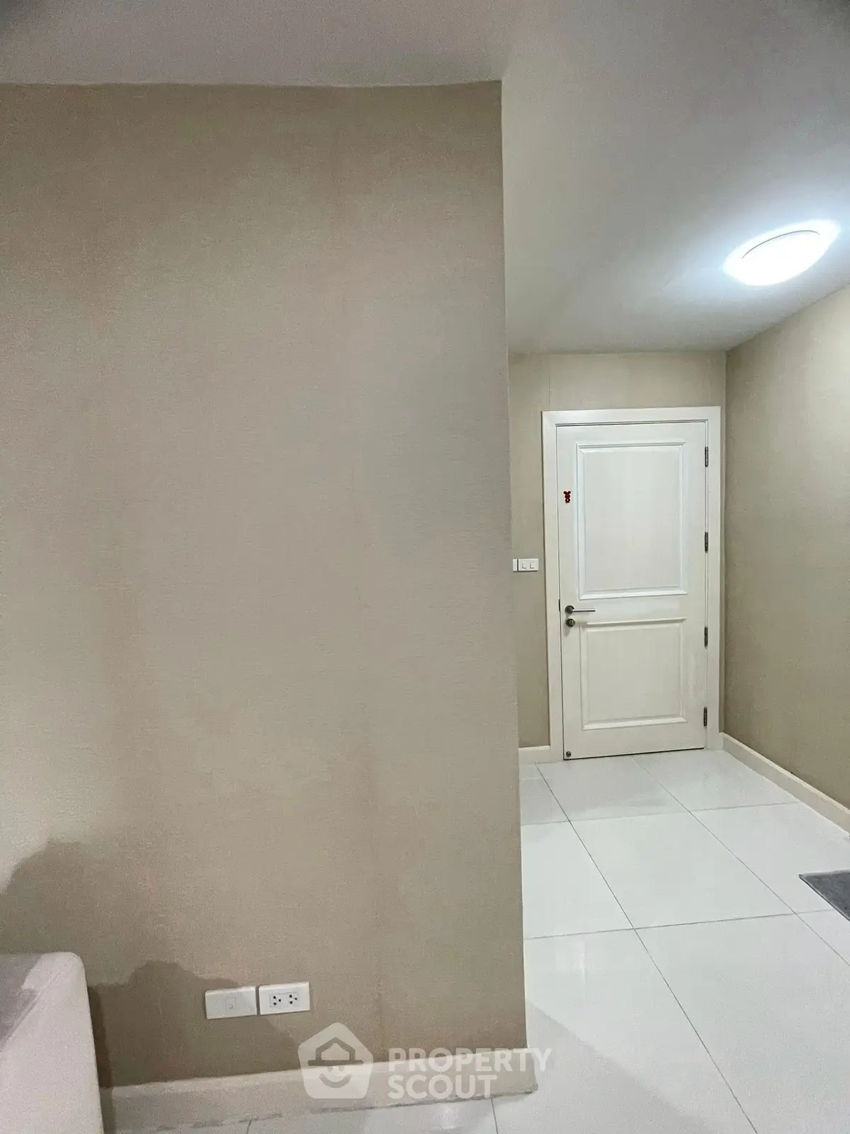 Modern apartment entrance with sleek white door and minimalist design