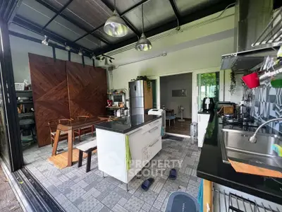 Modern kitchen with open layout and stylish decor, featuring stainless steel appliances and ample natural light.