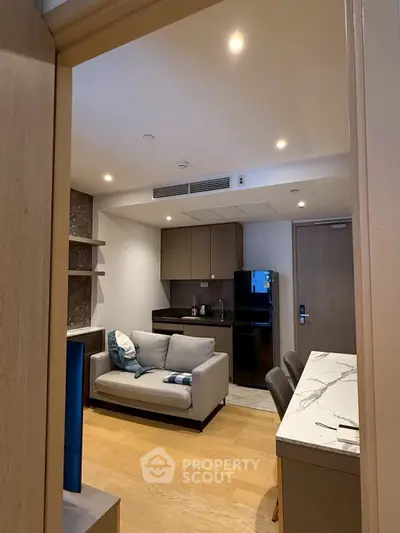 Modern apartment interior with cozy living area and sleek kitchen design.