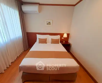 Cozy bedroom with elegant decor and natural light, featuring a comfortable bed and stylish furnishings.