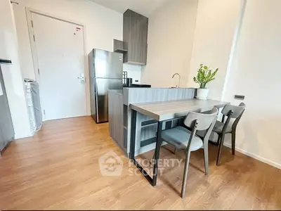 Modern kitchen with sleek design, featuring stainless steel appliances and stylish dining area.