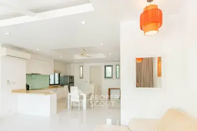 Spacious modern living room with open kitchen and stylish lighting