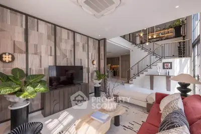 Luxurious modern living room with stylish decor and open staircase, perfect for elegant living.