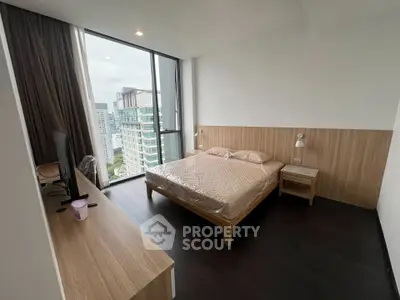 Modern bedroom with city view, featuring sleek furniture and large windows for natural light.