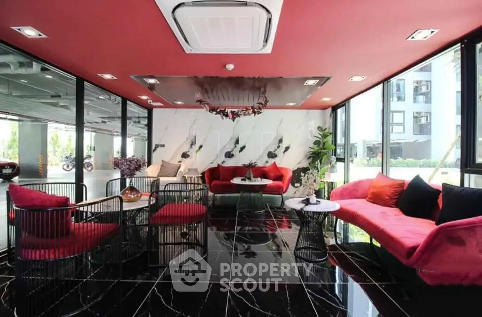 Luxurious modern living room with red accents and black marble flooring, perfect for stylish gatherings.