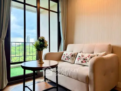 Cozy living room with elegant sofa and scenic balcony view in modern apartment.