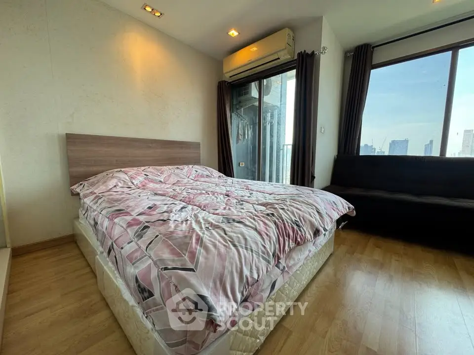 Spacious bedroom with city view and modern decor