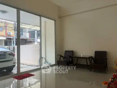 Spacious living room with sliding glass doors and modern furniture, perfect for relaxation.