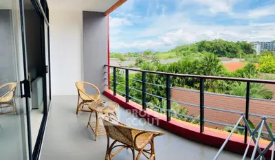 Spacious balcony with stunning view of lush greenery, perfect for relaxation and outdoor dining.