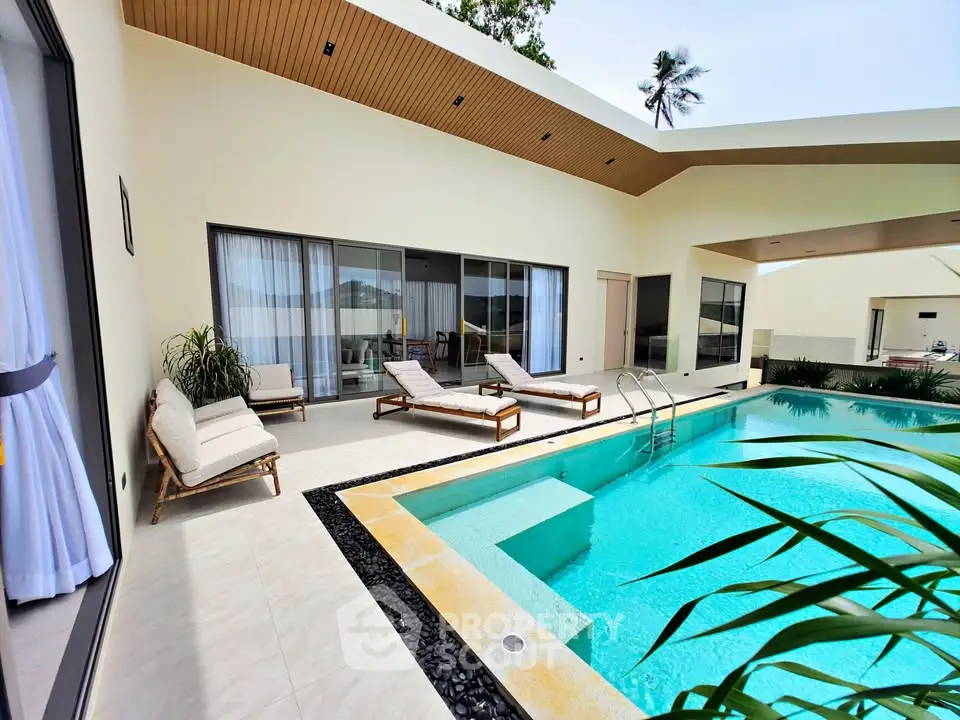 Luxurious modern villa with private pool and sun loungers, perfect for relaxation and entertainment.