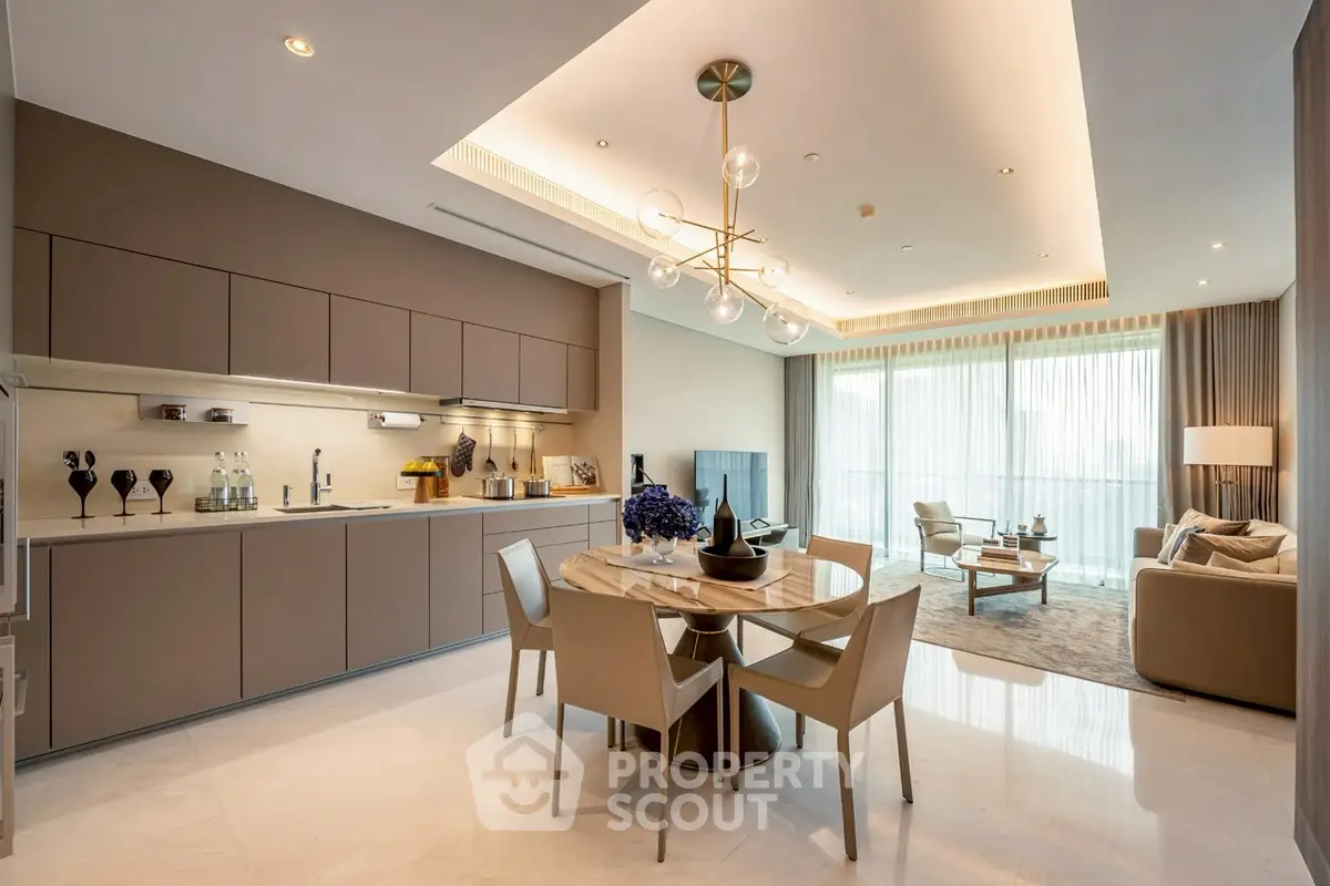 Luxurious open-plan kitchen and living room with modern decor and elegant lighting