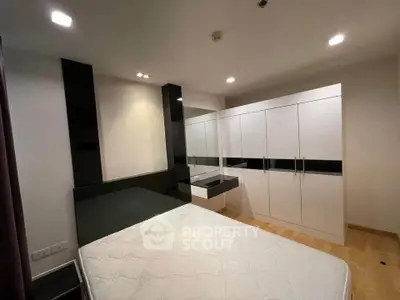 Modern bedroom with sleek built-in wardrobe and minimalist design
