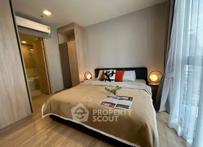 Modern bedroom with cozy decor and ensuite bathroom in stylish apartment